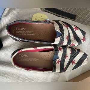 TOMS Black and White Slip-Ons with Red Accents